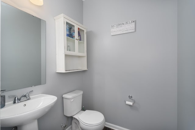 12062 Ambruzzi Dr, Walton, KY 41094 - half bathroom featuring a sink, toilet, and baseboards