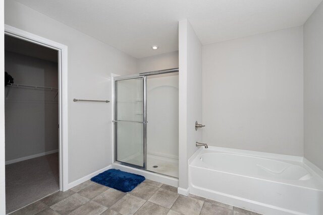 12062 Ambruzzi Dr, Walton, KY 41094 - full bathroom with a shower stall, a spacious closet, a garden tub, baseboards, and recessed lighting