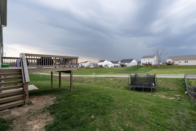 12062 Ambruzzi Dr, Walton, KY 41094 - view of grassy yard featuring a wooden deck, a trampoline, and a residential view