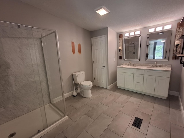 bathroom featuring a sink, toilet, a shower stall, and visible vents