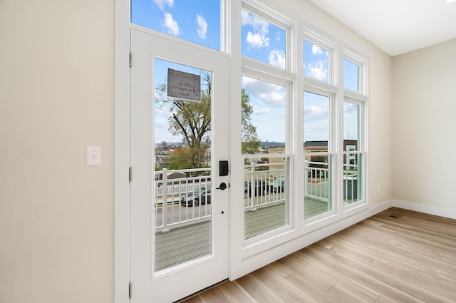entryway featuring baseboards and light wood-type flooring
