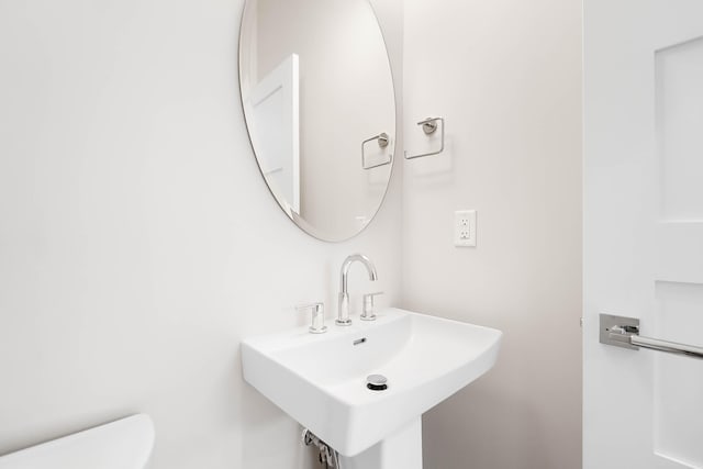 bathroom with toilet and a sink