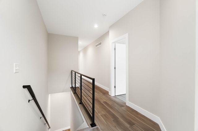 stairs featuring recessed lighting, baseboards, visible vents, and wood finished floors