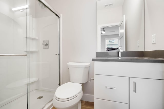 full bath featuring toilet, visible vents, baseboards, and a stall shower
