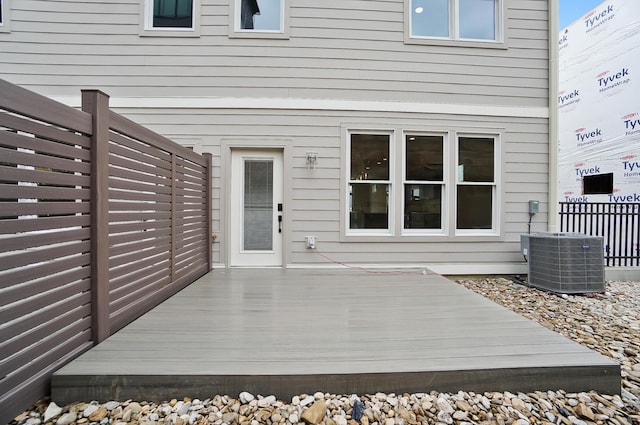 wooden deck featuring central AC unit and fence