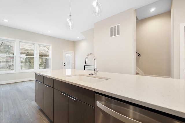kitchen with dishwasher, light stone counters, hanging light fixtures, visible vents, and a sink