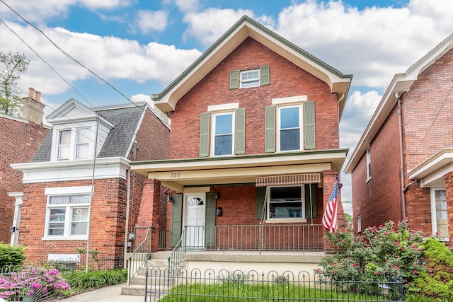 traditional home with a porch and brick siding
