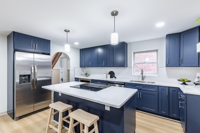 kitchen featuring blue cabinets, a sink, light wood-style floors, stainless steel refrigerator with ice dispenser, and black electric cooktop