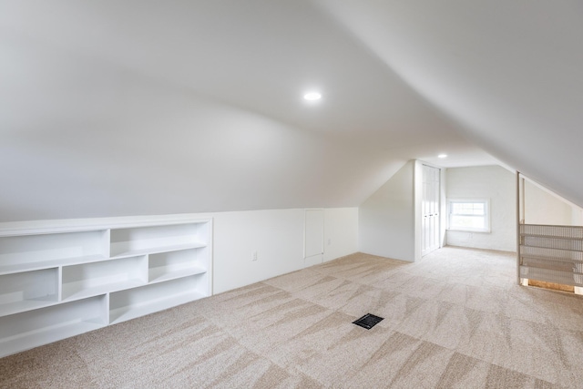 additional living space featuring carpet flooring, lofted ceiling, and recessed lighting