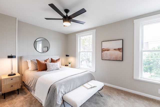bedroom featuring baseboards, multiple windows, and carpet flooring