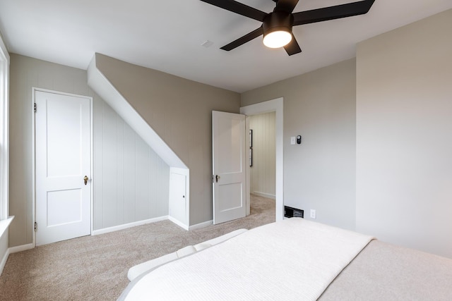 bedroom with light colored carpet, baseboards, and ceiling fan