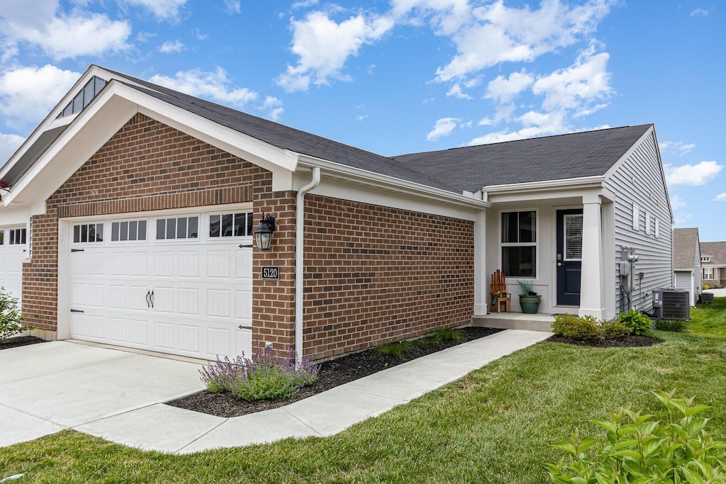 5120 Limerick Ct, Union, KY 41091 - single story home featuring an attached garage, brick siding, driveway, a front yard, and central AC unit