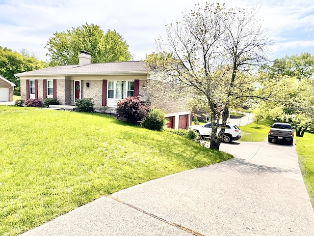 ranch-style home with brick siding, a garage, a front lawn, and a chimney