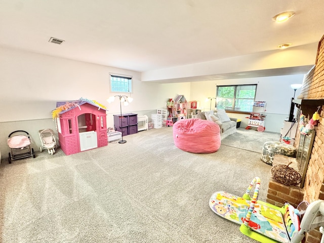 game room with a healthy amount of sunlight, visible vents, and carpet floors