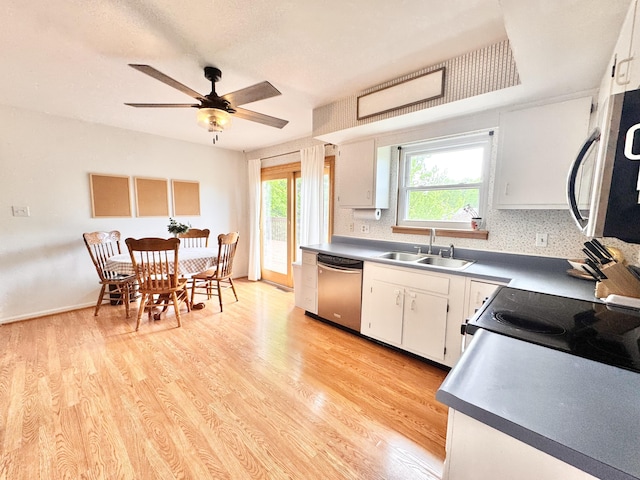 kitchen featuring a sink, stainless steel appliances, light wood-type flooring, ceiling fan, and white cabinets