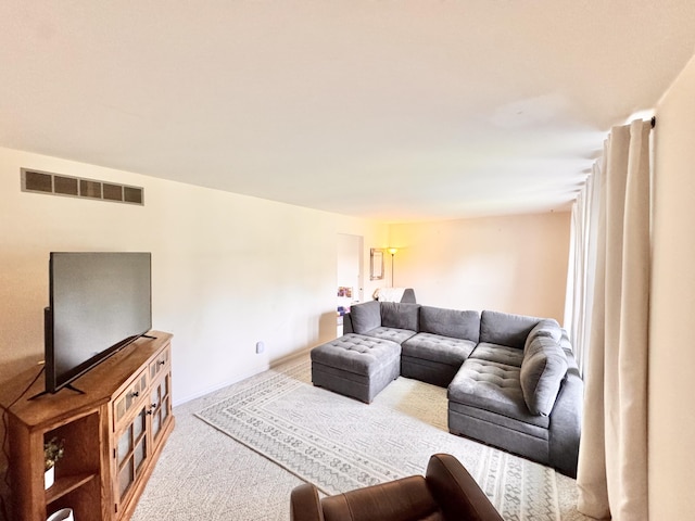 carpeted living area with visible vents and baseboards