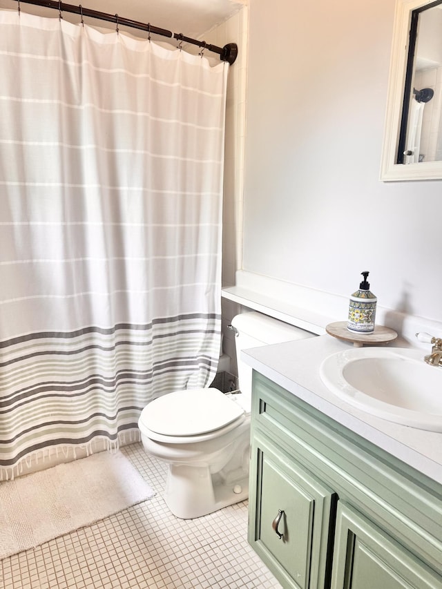 bathroom featuring vanity, toilet, a shower with curtain, and tile patterned flooring