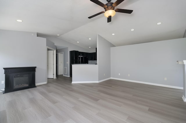 2387 Ambrato Way Unit 2-307, Covington, KY 41017 - unfurnished living room with a glass covered fireplace, ceiling fan, light wood-type flooring, lofted ceiling, and recessed lighting