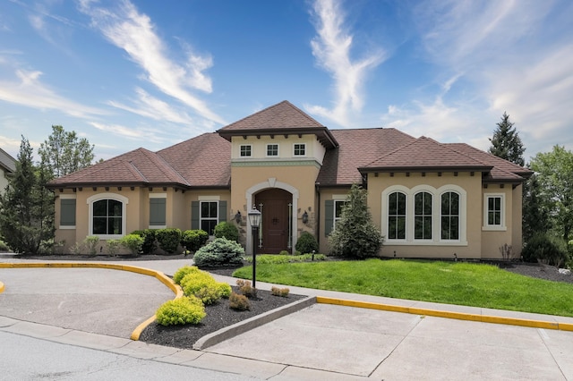 2387 Ambrato Way Unit 2-307, Covington, KY 41017 - mediterranean / spanish-style house with stucco siding and a front lawn