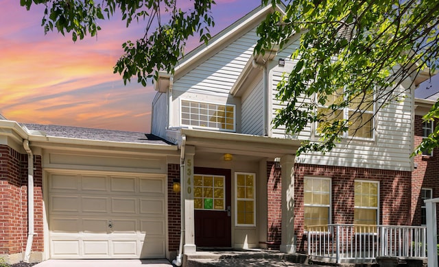 5340 Millstone Ct Unit 8A, Taylor Mill, KY 41015 - traditional-style home with brick siding, a garage, driveway, and covered porch