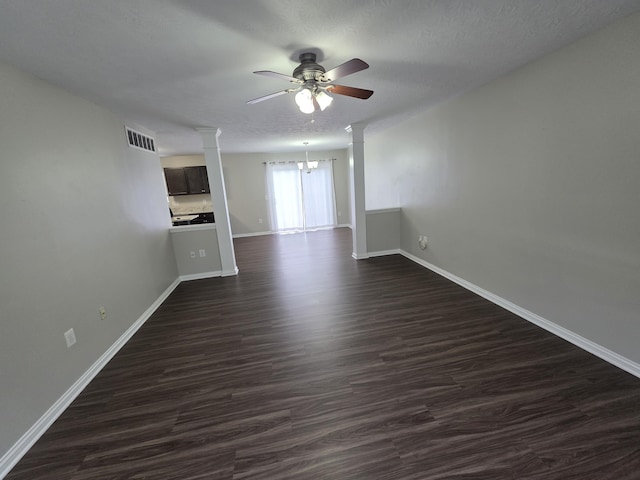 2964 Holly Hill Dr, Burlington, KY 41005 - empty room with ceiling fan with notable chandelier, ornate columns, visible vents, dark wood-style flooring, and baseboards