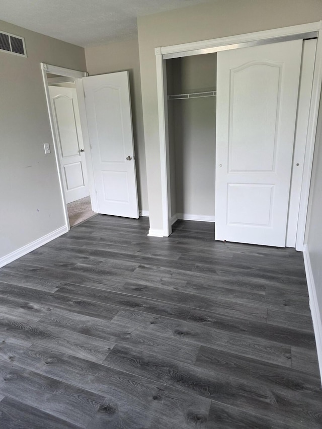 2964 Holly Hill Dr, Burlington, KY 41005 - unfurnished bedroom featuring baseboards, a closet, dark wood finished floors, and visible vents