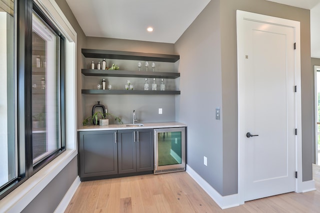 1200 Vistapointe Dr, Covington, KY 41011 - indoor wet bar with beverage cooler, light wood-style flooring, plenty of natural light, and recessed lighting