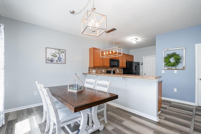 47 Nicole Dr, Independence, KY 41051 - dining room featuring a chandelier, wood finished floors, and baseboards
