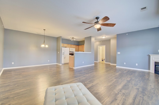 517 Ivy Ridge Dr, Cold Spring, KY 41076 - unfurnished living room featuring a ceiling fan, dark wood-type flooring, baseboards, and a chandelier