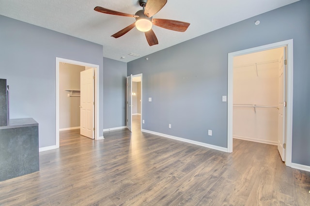 517 Ivy Ridge Dr, Cold Spring, KY 41076 - unfurnished bedroom featuring a walk in closet, a closet, wood finished floors, baseboards, and a ceiling fan