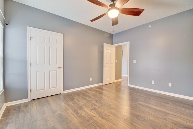 517 Ivy Ridge Dr, Cold Spring, KY 41076 - unfurnished bedroom with baseboards, wood finished floors, and a ceiling fan