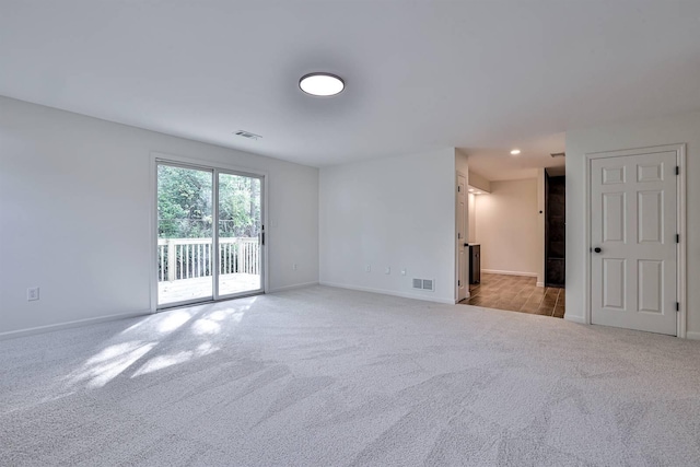 empty room with light carpet and baseboards