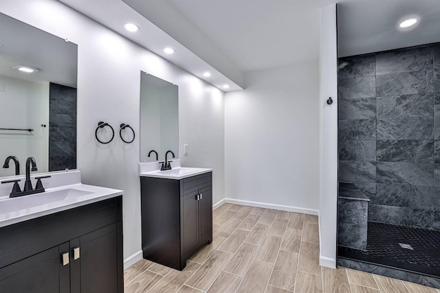 full bath with recessed lighting, walk in shower, two vanities, baseboards, and wood tiled floors