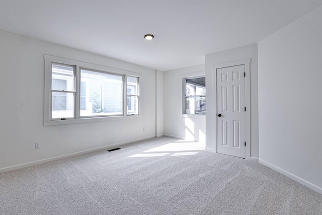 empty room with carpet flooring and baseboards