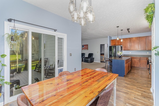 850 Stablewatch Dr, Independence, KY 41051 - dining area with a chandelier, a textured ceiling, and light wood finished floors