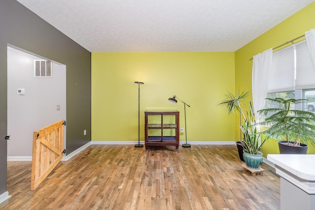 850 Stablewatch Dr, Independence, KY 41051 - sitting room with wood finished floors, a textured ceiling, and baseboards
