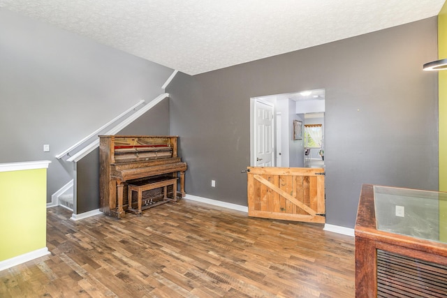 850 Stablewatch Dr, Independence, KY 41051 - sitting room with wood finished floors, stairway, a textured ceiling, and baseboards