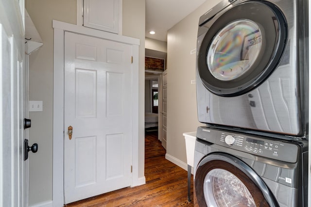 laundry area featuring stacked washer / dryer, wood finished floors, baseboards, and recessed lighting