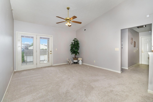 carpeted spare room with lofted ceiling, a ceiling fan, and baseboards