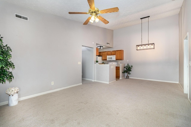 unfurnished living room with light colored carpet, baseboards, a textured ceiling, ceiling fan, and high vaulted ceiling