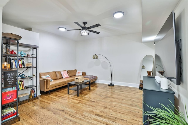 living room featuring a ceiling fan, wood finished floors, baseboards, and recessed lighting