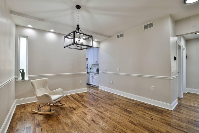sitting room featuring wood finished floors, baseboards, a chandelier, and recessed lighting