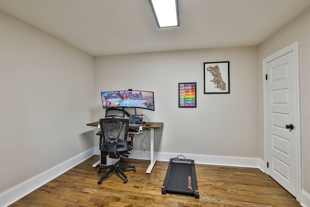 office space featuring baseboards and wood finished floors