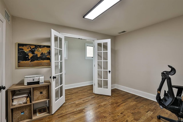 home office with french doors, wood finished floors, and baseboards
