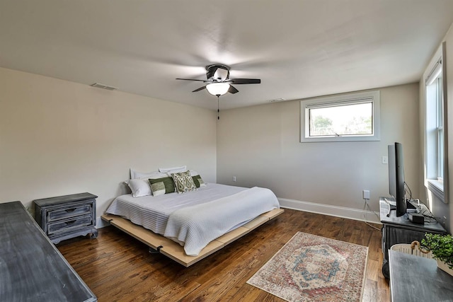 bedroom with wood finished floors, baseboards, and a ceiling fan