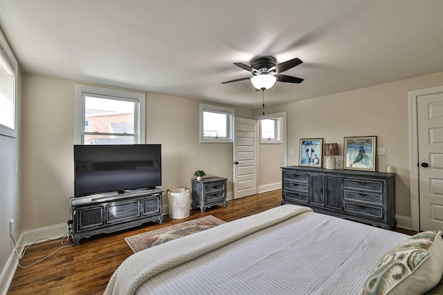 bedroom with baseboards, multiple windows, dark wood-style flooring, and a ceiling fan