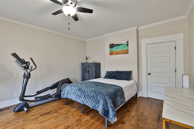 bedroom with crown molding, wood finished floors, baseboards, and ceiling fan