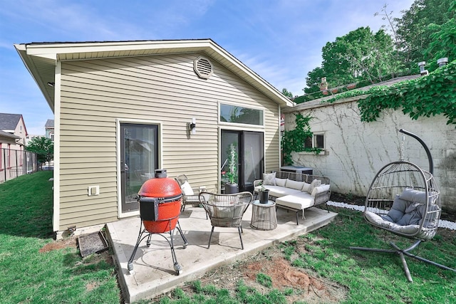 rear view of house featuring an outdoor living space and a patio