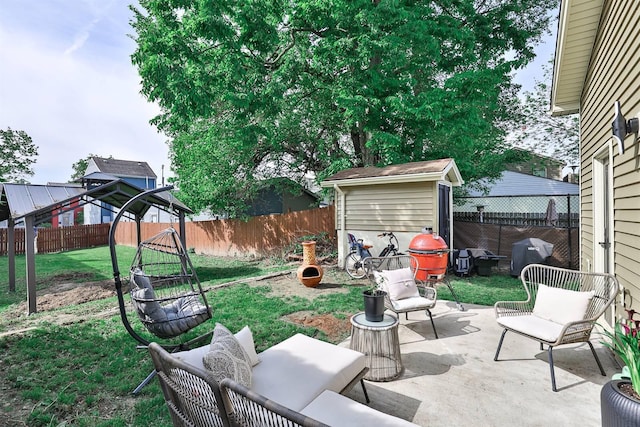 view of patio / terrace with a storage shed, an outbuilding, and grilling area
