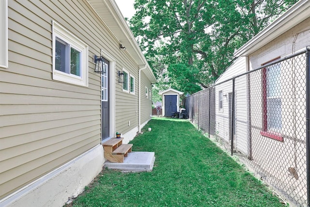 view of yard with entry steps, a shed, and an outbuilding